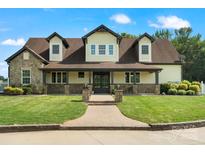 Charming two-story home with stone accents, inviting front porch, and lush green lawn at 2521 Neely Store Rd, Rock Hill, SC 29730