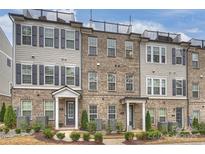 Beautiful brick townhomes with a rooftop patio and landscaping at 310 N Dotger N Ave # 4, Charlotte, NC 28204