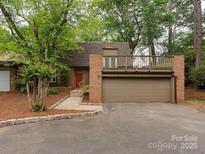 Two-story home with attached garage and balcony overlooking driveway at 4025 Woodfox Dr, Charlotte, NC 28277