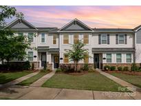 Attractive townhomes boast stone accents, vinyl siding, manicured lawns and inviting curb appeal at 4117 Galloway Park Dr, Charlotte, NC 28262