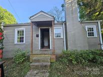 Charming exterior view showcasing the entryway and brick chimney, inviting you to explore the house at 435 W Sharpe St, Statesville, NC 28677