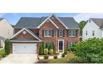 Charming two-story brick home with black shutters, landscaped yard, and an attached two-car garage at 4658 Cedar Rock Dr, Charlotte, NC 28273