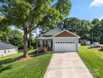 Charming single-Gathering home with a well-maintained lawn and an attached two-car garage at 6578 Bopre Ln, Denver, NC 28037