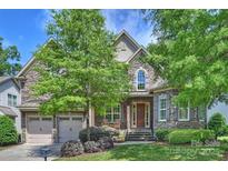 Beautiful stone-faced two-story home with a well-manicured lawn and attached two-car garage at 7428 Edenbridge Ln, Charlotte, NC 28226