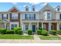 Charming townhome with a well-manicured lawn, inviting entryway, and classic architectural details at 13358 Calloway Glen Dr, Charlotte, NC 28273