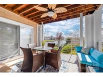 Inviting covered patio features comfortable seating and beautiful water view at 18631 Harborside Dr, Cornelius, NC 28031