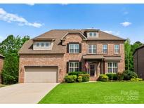 Traditional brick home with manicured lawn, attached garage, and inviting front entrance at 2606 Walker Rd, Matthews, NC 28105