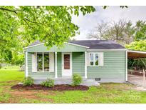 Charming home featuring a quaint front porch, complemented by manicured landscaping at 275 N Garrison Rd, Rock Hill, SC 29730