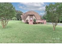 Unique dome home featuring a deck and a well-maintained lawn at 443 Troutman Farm Rd, Statesville, NC 28677