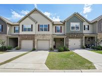 Charming townhouse featuring a one-car garage, brick accents and inviting curb appeal at 5254 Spanish Ivy Ln # 133, Indian Land, SC 29707
