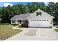 Charming ranch home with a two-car garage, well-manicured lawn, and a sidewalk leading to the front door at 5764 Grassy Creek Rd, Denver, NC 28037
