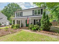 Charming two-story home with a well-manicured lawn and a welcoming front porch at 618 Heathermoor Ct, Charlotte, NC 28209