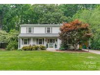 Charming home featuring a well-manicured lawn, mature trees, and attractive curb appeal at 6621 Ronda Ave, Charlotte, NC 28211