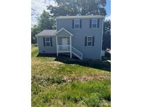 Charming two-story home with blue siding, white trim, and a welcoming front porch at 7 Scott Sw St, Concord, NC 28025