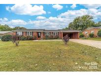 Charming brick home features a well-manicured lawn and a convenient carport at 814 Rhodann Dr, Shelby, NC 28152