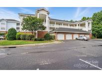 Multi-story condo building featuring brick accents, multiple balconies and attached garages at 8731 Coralbell Ln, Charlotte, NC 28213