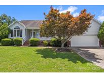 Charming single Gathering home with an attached garage and well-maintained lawn at 1028 Swaying Oats Dr, York, SC 29745