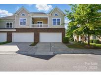 Charming townhome with two-car garage, balcony, and brick facade at 11209 Lazio Ln # 1, Charlotte, NC 28277
