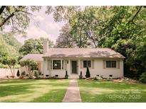Charming one-story home with a lush green lawn and mature trees providing shade at 1184 Thornwell Ave, Rock Hill, SC 29732
