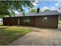 Traditional one story home with brick and siding and a concrete driveway at 140 Porter Rd, Statesville, NC 28625