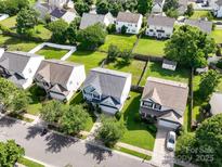 An aerial view of a neighborhood showcasing well-maintained lawns and neatly fenced yards on a sunny day at 14501 Asheton Creek Dr, Charlotte, NC 28273