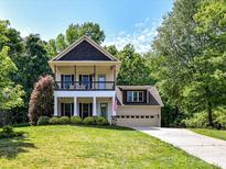 Inviting two-story home featuring a charming front porch and well-manicured lawn at 3801 Creek Ridge Dr, Denver, NC 28037