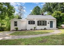 Charming one-story home with black shutters, a gray roof, and a well-manicured front yard at 3920 Admiral Ave, Charlotte, NC 28205