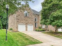 Two-story brick home featuring an attached two-car garage and a well-manicured lawn at 410 Deer Brush Ln, Waxhaw, NC 28173