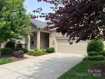 Charming single-Gathering home featuring a stone facade and well-maintained landscaping at 5214 Polo Gate Blvd, Charlotte, NC 28216