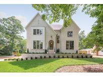 Elegant two-story home boasts a lush green lawn and charming brick facade at 5601 Robinhood Rd, Charlotte, NC 28211