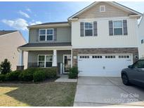 Charming two-story home with a two-car garage, stone accents, and well-maintained landscaping at 664 Cape Fear St, Fort Mill, SC 29715