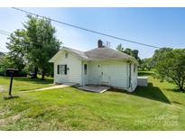 Charming single-story home with a well-maintained lawn and bright white siding at 711 Wood St, Albemarle, NC 28001