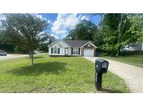 Charming single-story home with well-manicured lawn, garage, and inviting front entrance at 1062 Piney Church Rd, Concord, NC 28025