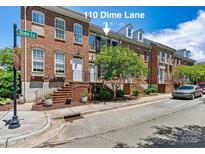 Charming brick townhome with mature landscaping and a welcoming entrance at 110 Dime Ln, Mooresville, NC 28117