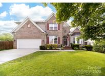 Charming two-story brick home featuring a well-manicured lawn and inviting curb appeal at 143 Heywatchis Dr, Mooresville, NC 28115