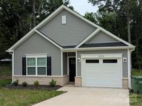 Charming single-story home with gray siding, black shutters, and an attached one-car garage at 1604 N Main St, Mount Holly, NC 28120