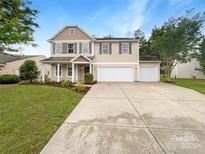 Charming two-story home with landscaped yard and a three car attached garage at 1814 Tradd Ave, Clover, SC 29710