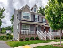 Charming two-story home with a welcoming front porch, gray siding, and well-maintained landscaping at 2001 Laurel Village Cir, Belmont, NC 28012