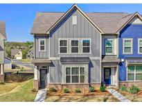 Charming townhome featuring modern gray siding and well-manicured landscaping and inviting curb appeal at 2001 Laurel Village Cir, Belmont, NC 28012