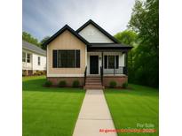 Charming home featuring a manicured lawn, brick foundation, and welcoming front porch, creating an inviting curb appeal at 208 Malvern Sw Dr, Concord, NC 28025