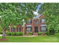 Traditional two-story brick home with manicured lawn and mature trees at 20812 Decora Dr, Cornelius, NC 28031