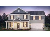 Charming two-story home boasts neutral siding, dark shutters, covered front porch, and an attached two-car garage at 279 Miramar Dr, York, SC 29745