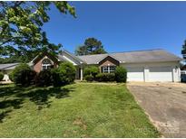 Well-maintained single story home with brick and siding, a green lawn, and an attached two car garage at 3240 St Vincent Dr, Claremont, NC 28610