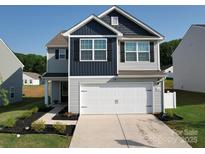 Charming two-story home featuring a two car garage, and manicured landscaping at 3322 Brighton Dr, Gastonia, NC 28052