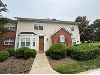 Inviting townhouse showcasing manicured landscaping, siding, brick accents, and a pathway to the front door at 3602 Melrose Cottage Dr, Matthews, NC 28105