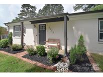 Charming front porch with a bench and manicured landscaping at 3623 Braden Dr, Charlotte, NC 28216