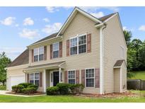 Charming two-story home featuring neutral siding, brown shutters, and a well-manicured lawn at 4004 Shasta Cir, Clover, SC 29710