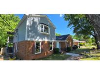 Charming two-story home with a brick facade and gray siding, featuring a well-maintained front yard at 401 Pamela St, Gastonia, NC 28054