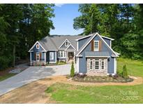 Charming two-story home featuring a landscaped yard and a long driveway at 434 Breezewood Dr, Belmont, NC 28012