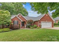 Charming brick home with manicured lawn, two-car garage, and inviting front entrance at 149 Harbor Landing Dr, Mooresville, NC 28117